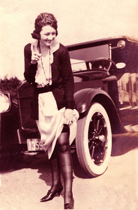 Aunt Vilma adjusting her garter in front of Uncle Max's auto at their Woodstock, NY weekend cabin.